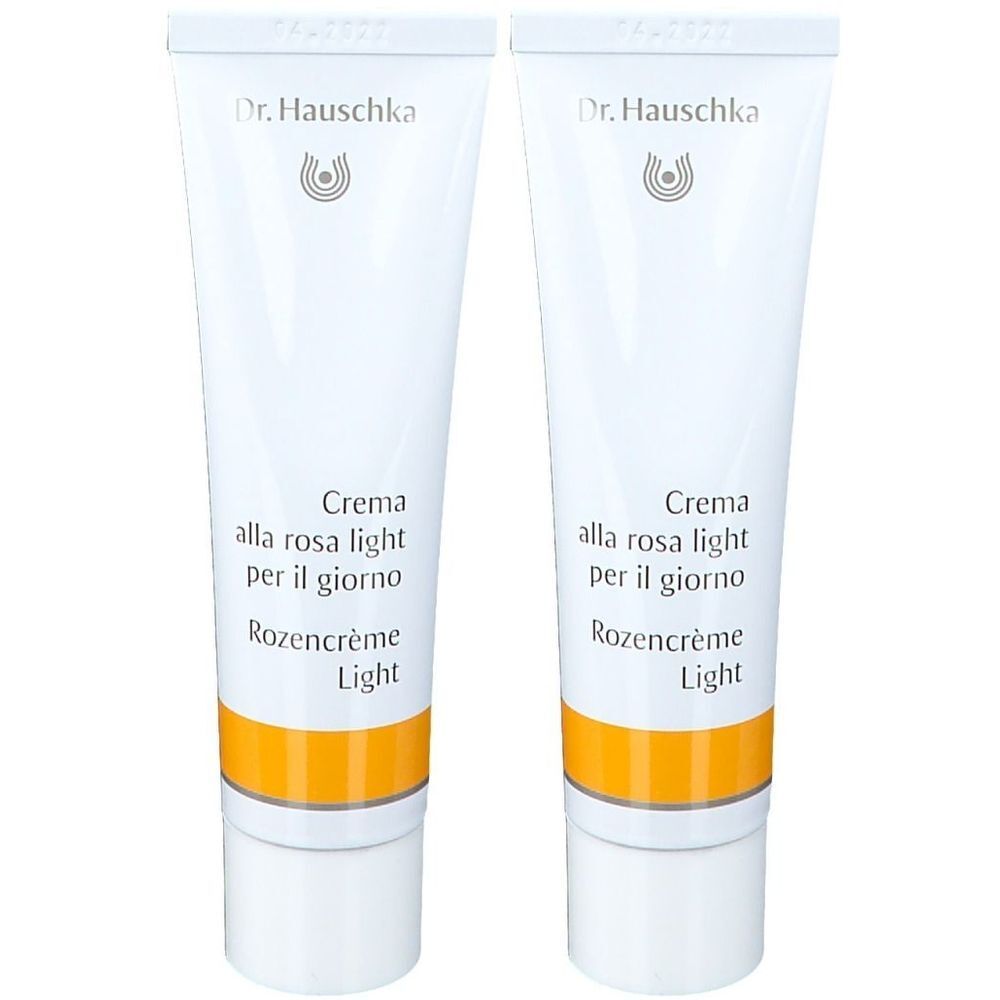 Deux tubes de crème. Inscription: Dr. Hauschka, Rosencreme Light. Tubes blancs avec bande jaune.