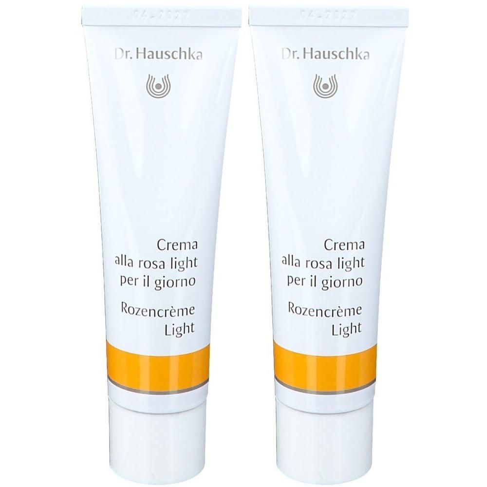 Deux tubes de crème. Inscription: Dr. Hauschka, Rosencreme Light. Tubes blancs avec bande jaune.