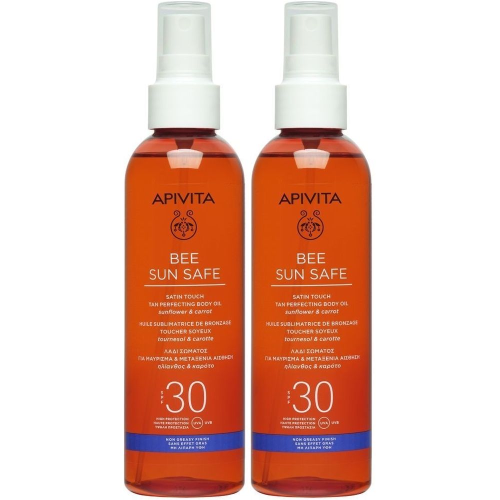 Deux flacons Apivita Bee Sun Safe. Huile orange avec vaporisateur blanc. Texte: SPF 30, Bee Sun Safe, Huile Sublimatrice.