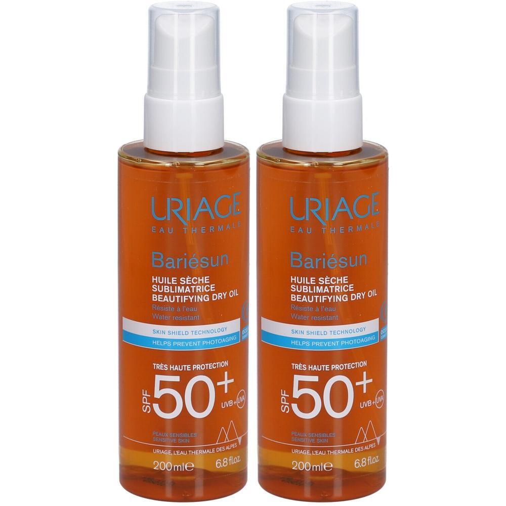 Deux flacons de URIAGE Bariésun Huile Sèche SPF50+. Liquide orangé dans des flacons transparents avec vaporisateur blanc. Texte: SPF50+.