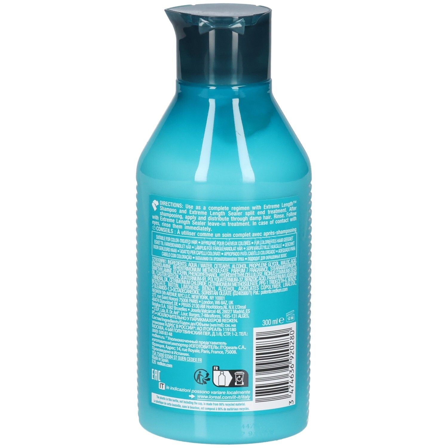 Dos d'une bouteille turquoise avec bouchon bleu foncé. Informations textuelles et code-barres. Contient REDKEN Extreme Length Conditioner.