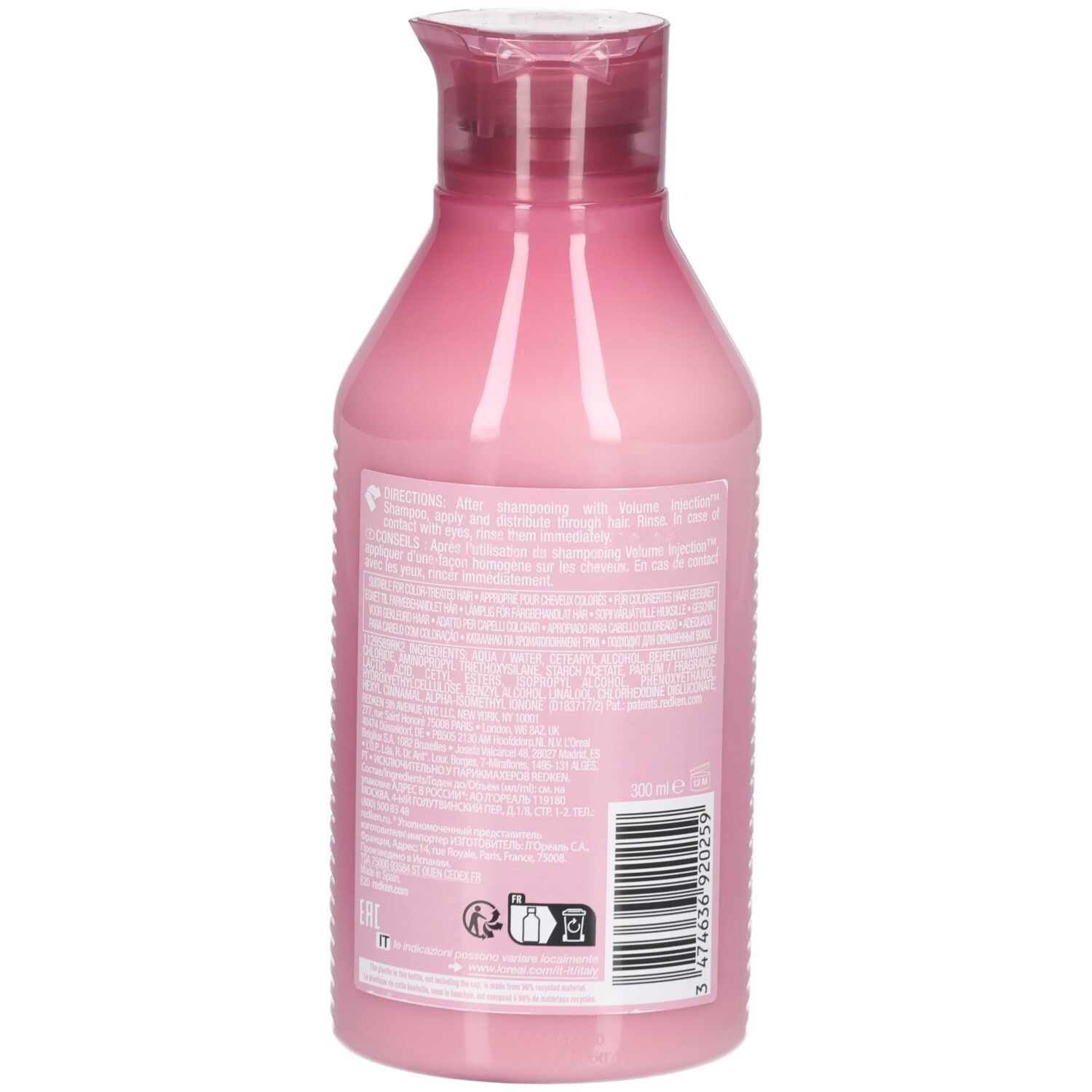 Vue arrière d'un flacon rose avec bouchon rouge. Texte, code-barres et symboles au dos.