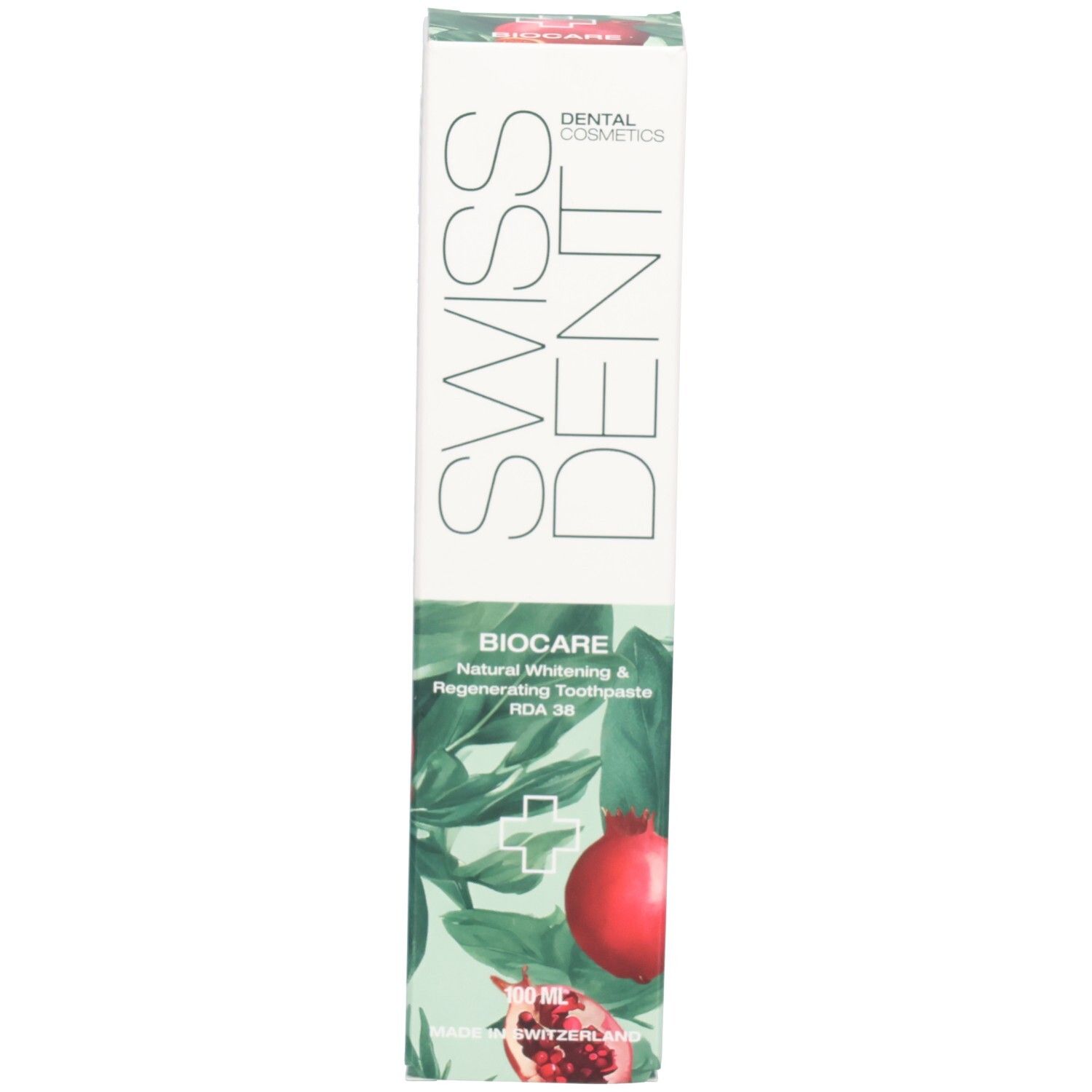 Boîte de dentifrice. Inscription : SWISSDENT, BIOCARE. Illustration de grenade. Texte : Natural Whitening & Regenerating Toothpaste.