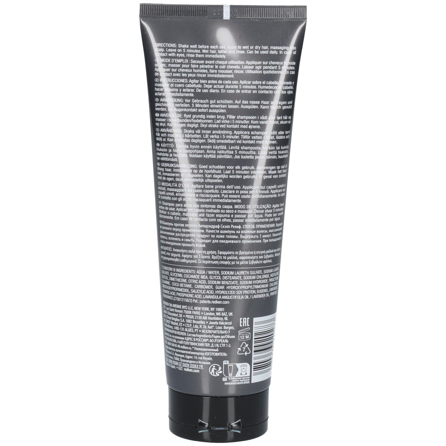 Dos d'un tube de shampooing gris. Texte avec instructions et ingrédients. Contient des informations sur l'utilisation et les ingrédients.