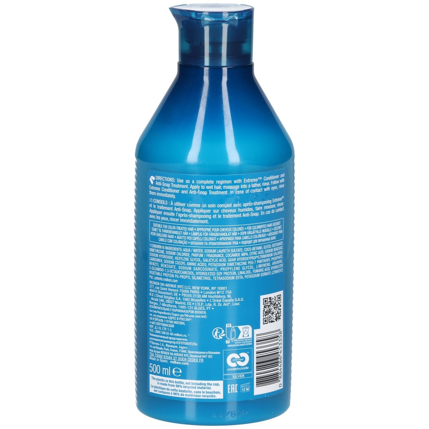 Dos du flacon de shampooing bleu. Texte avec instructions et ingrédients. Contient un code QR et un logo de recyclage.