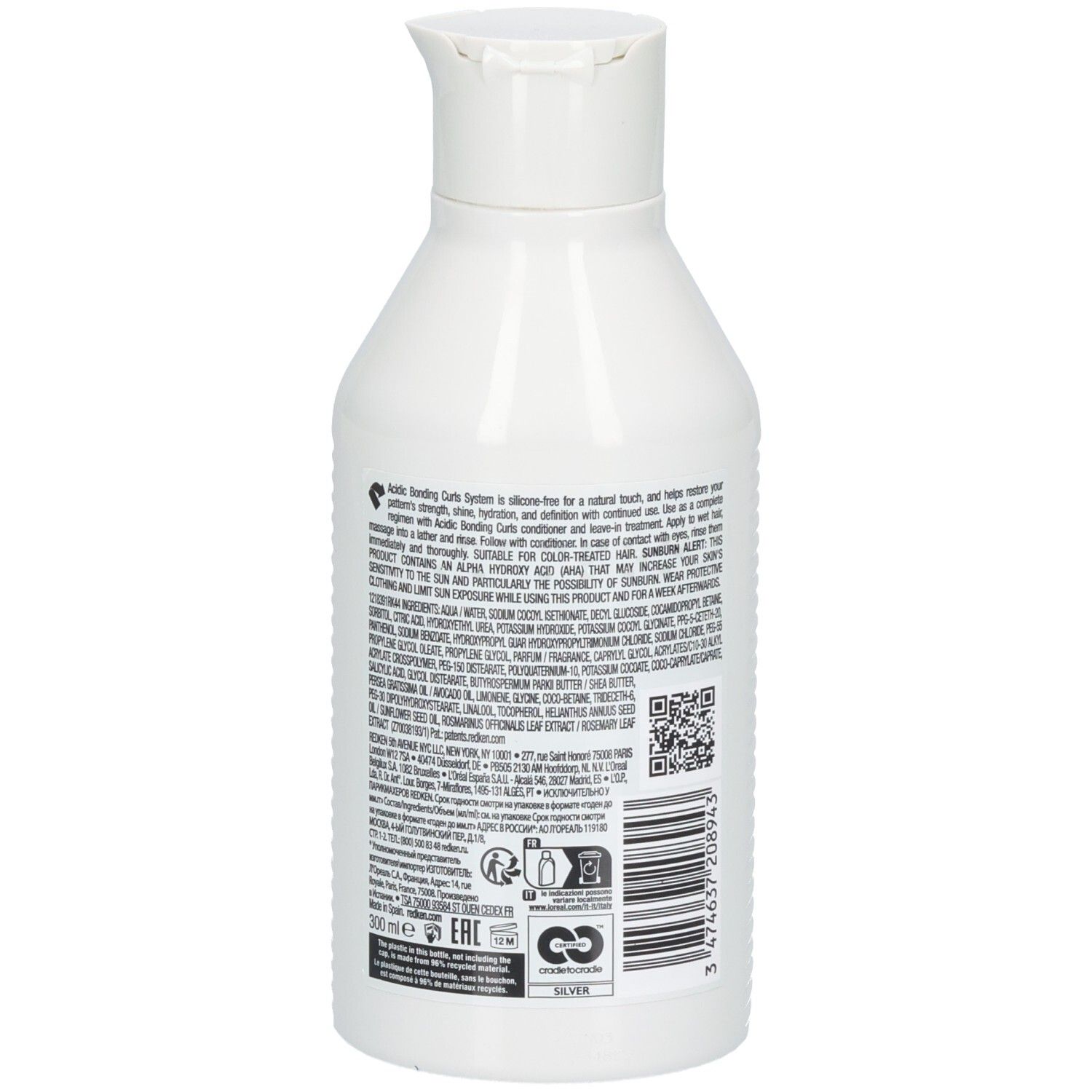 Dos d'un flacon Redken blanc. Texte avec ingrédients et code QR. 300 ml. Logo de recyclage argent.