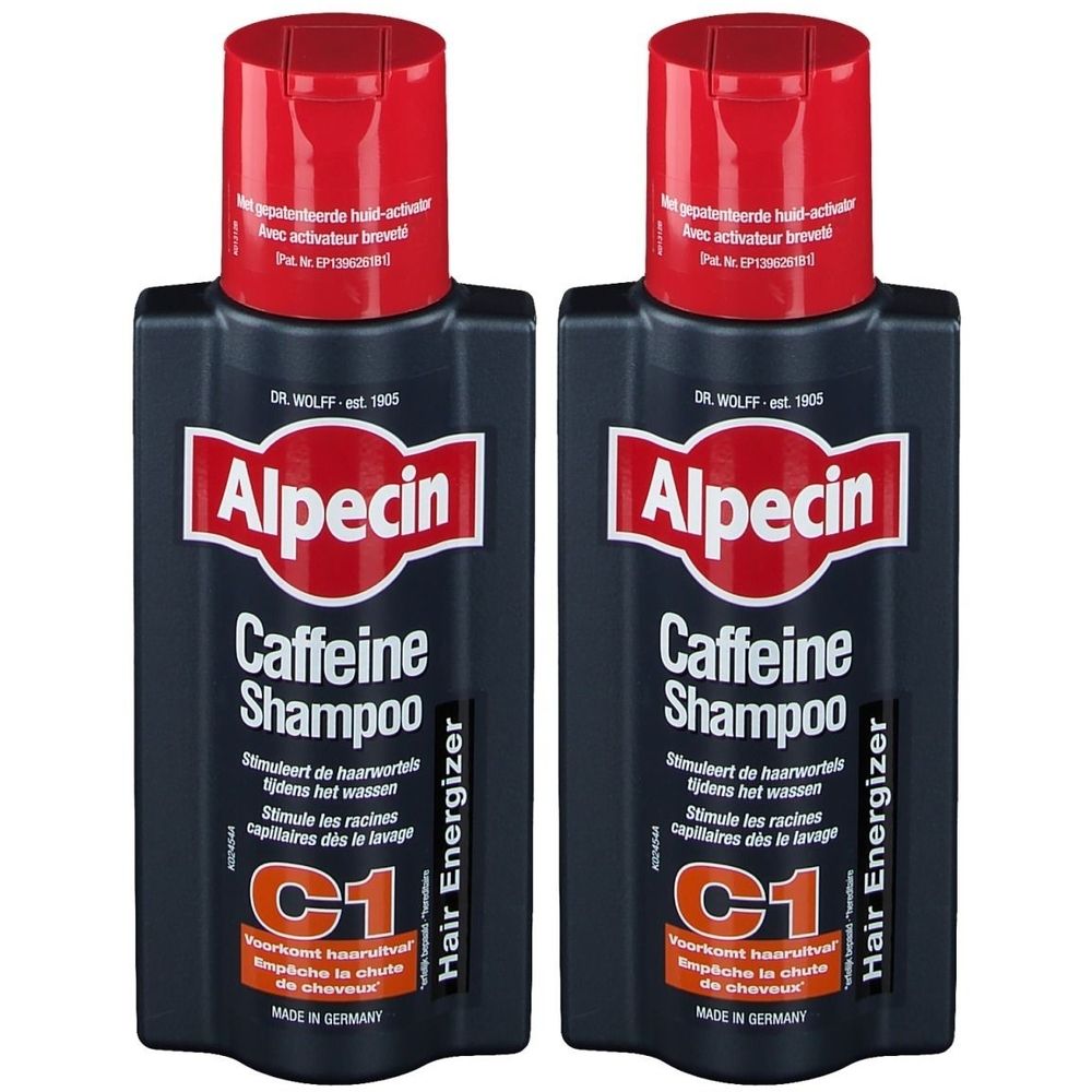 Deux flacons de shampooing Alpecin Caffein. Flacons noirs avec bouchon rouge. Écriture blanche.