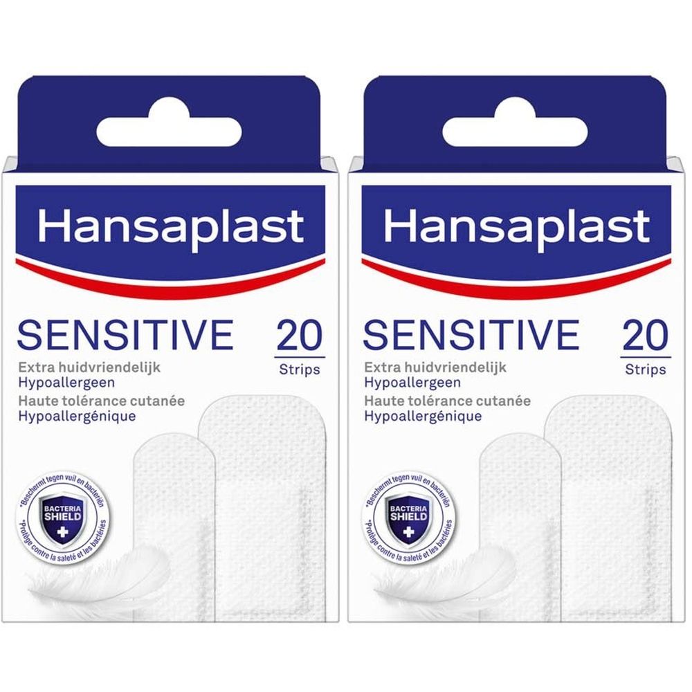 Deux boîtes de pansements Hansaplast SENSITIVE. Bandes blanches dans des boîtes. Inscription: SENSITIVE, 20 Strips.