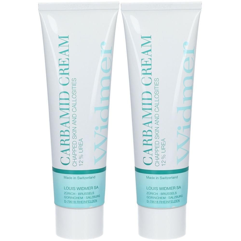 Deux tubes de crème Louis Widmer Carbamide. Inscription: Carbamide Cream, 12% Urée. Texte bleu sur fond blanc.