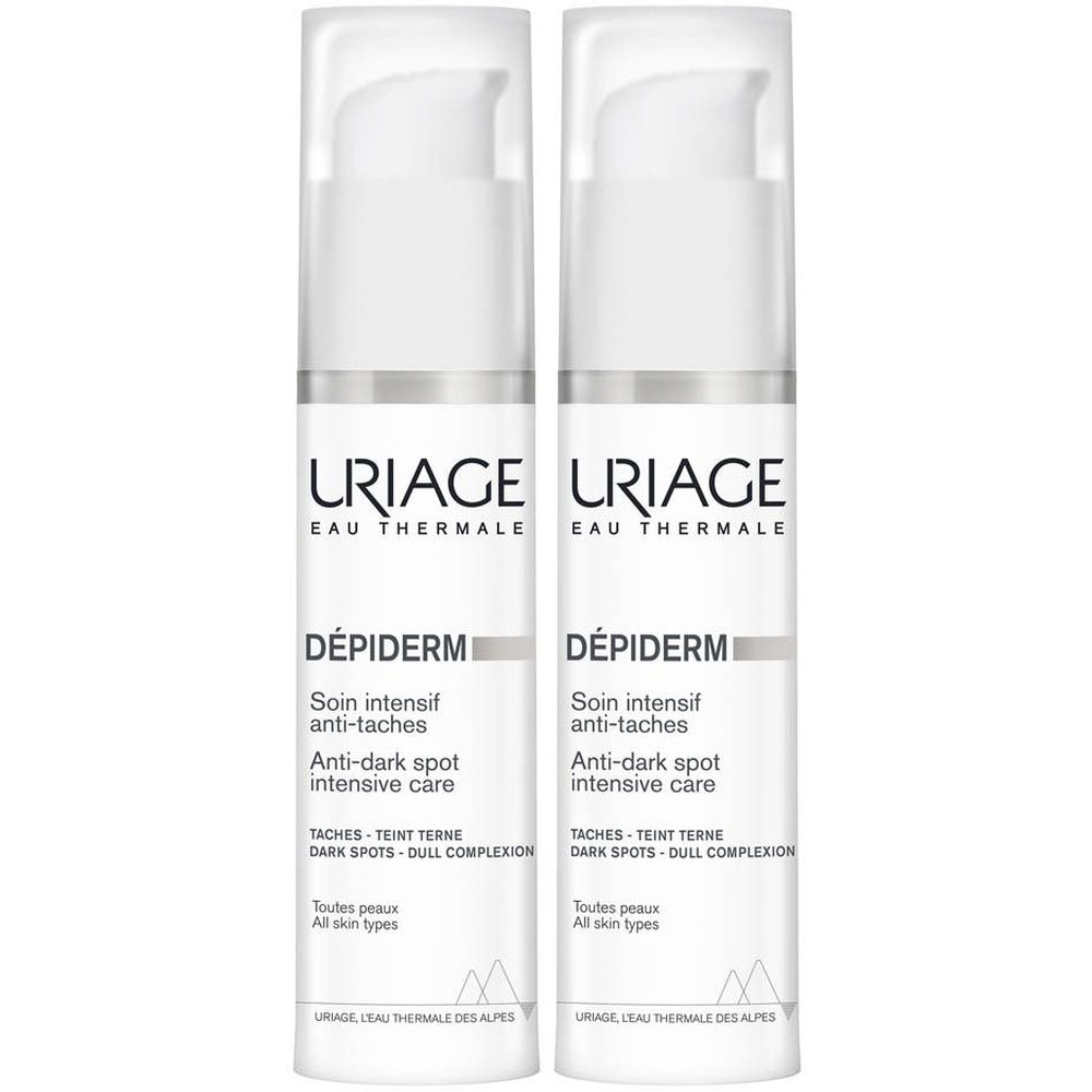 Deux flacons blancs Uriage Dépiderm avec pompe. Inscription: Soin intensif anti-taches, toutes peaux.