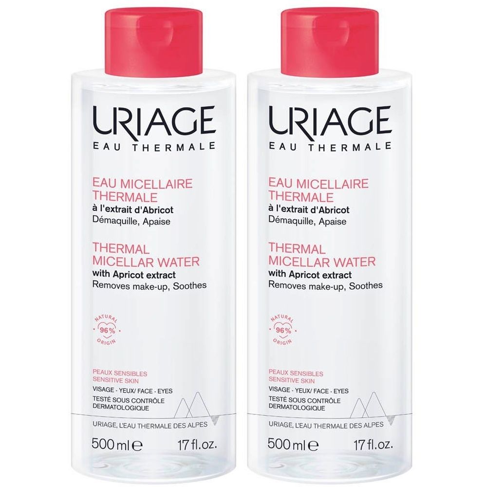 Deux flacons de URIAGE Eau micellaire Thermale. Liquide clair, bouchon rouge. Texte: Thermal Micellar Water, extrait d'abricot.