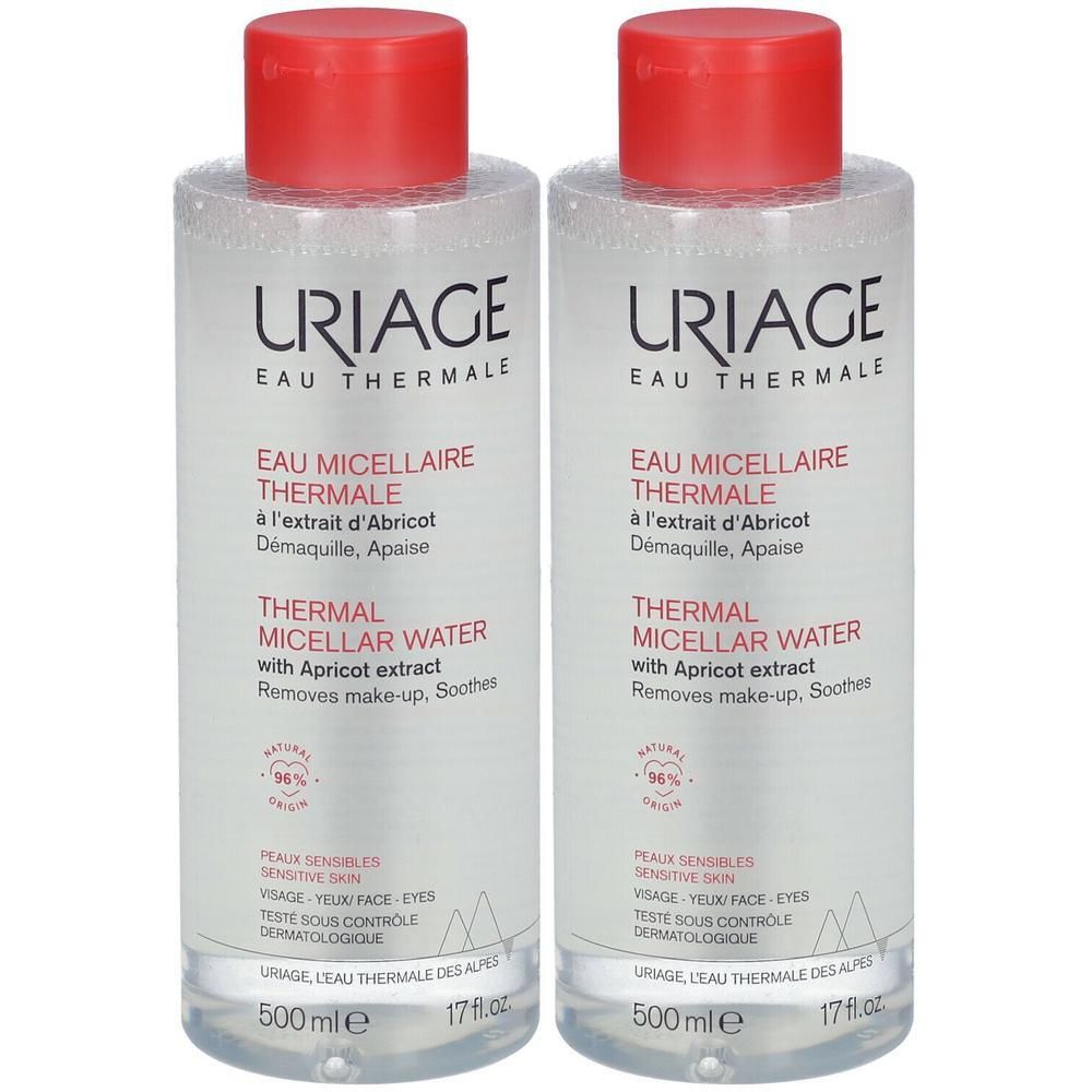 Deux flacons de URIAGE Eau micellaire Thermale. Liquide clair, bouchon rouge. Texte: Thermal Micellar Water, extrait d'abricot.