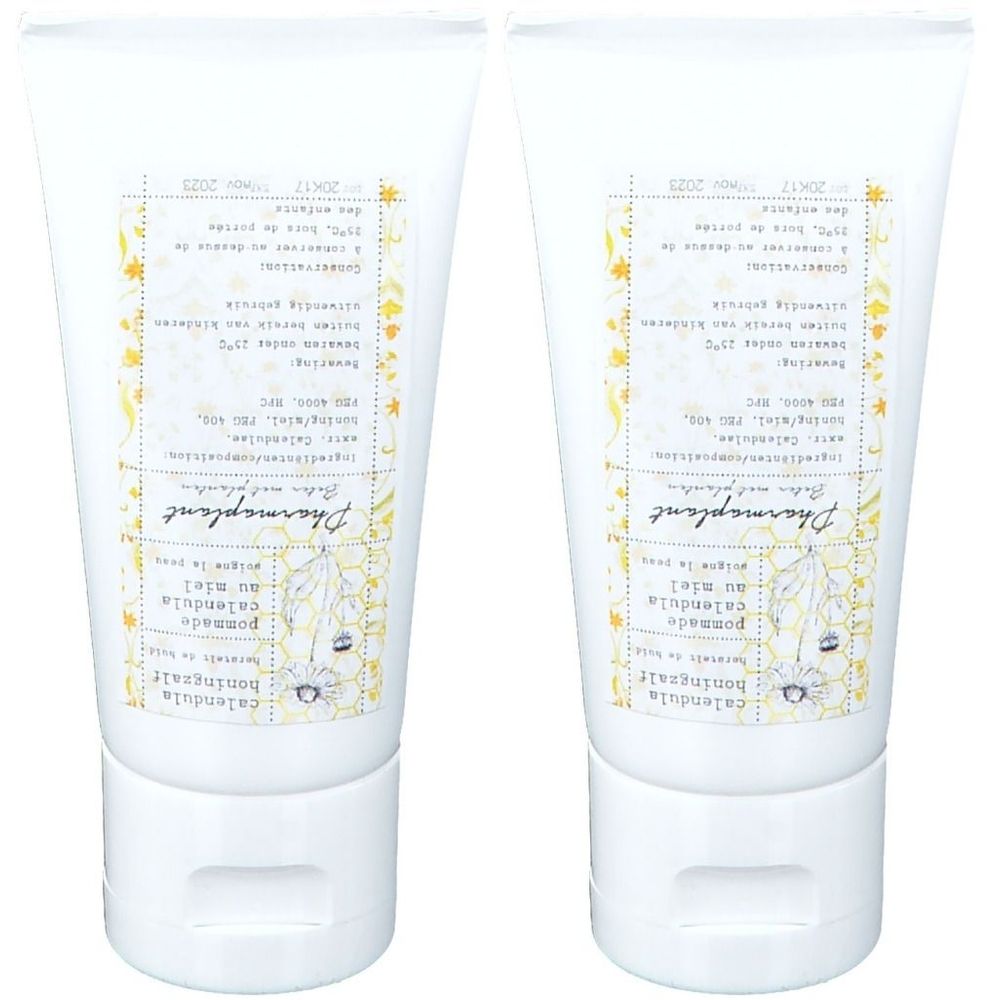 Deux tubes de Pommade calendula au miel Pharmaplant. Tubes blancs avec étiquette. Texte en français et néerlandais.