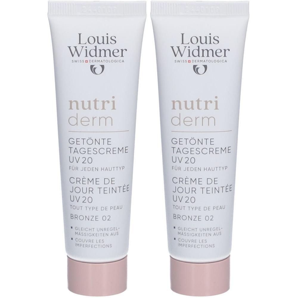 Deux tubes de crème de jour teintée Louis Widmer Nutriderm UV20 Bronze 02. Tubes blancs, texte et logo. Bouchon rose.