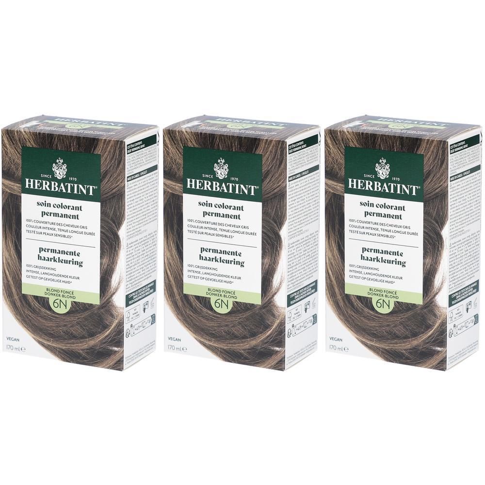 Trois boîtes Herbatint Soin Colorant Permanent 6N Blond Foncé. Emballage vert-brun avec informations et illustration de cheveux.