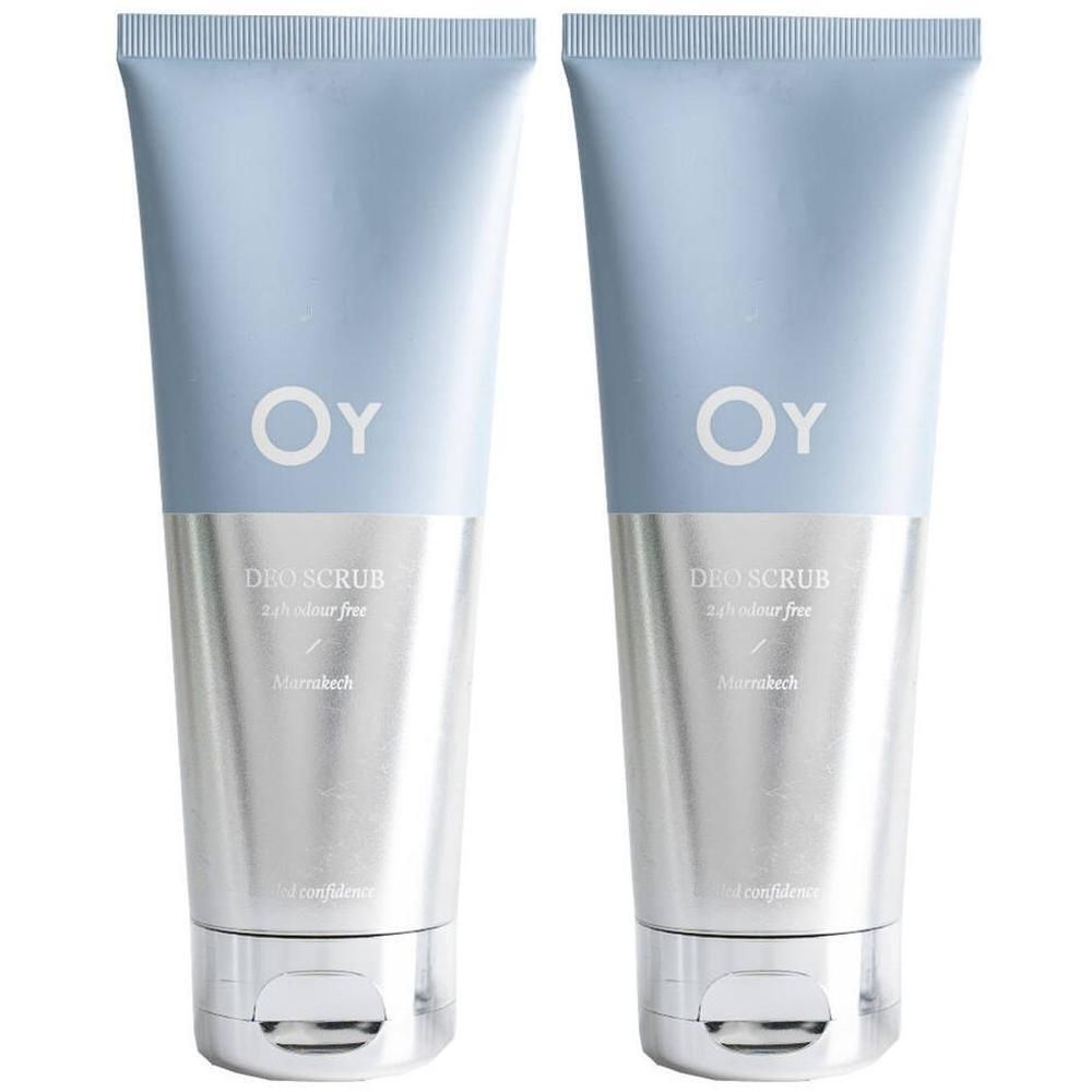 Deux tubes avec bouchon bleu et corps argenté. Logo OY et texte 'DEO SCRUB' visibles.