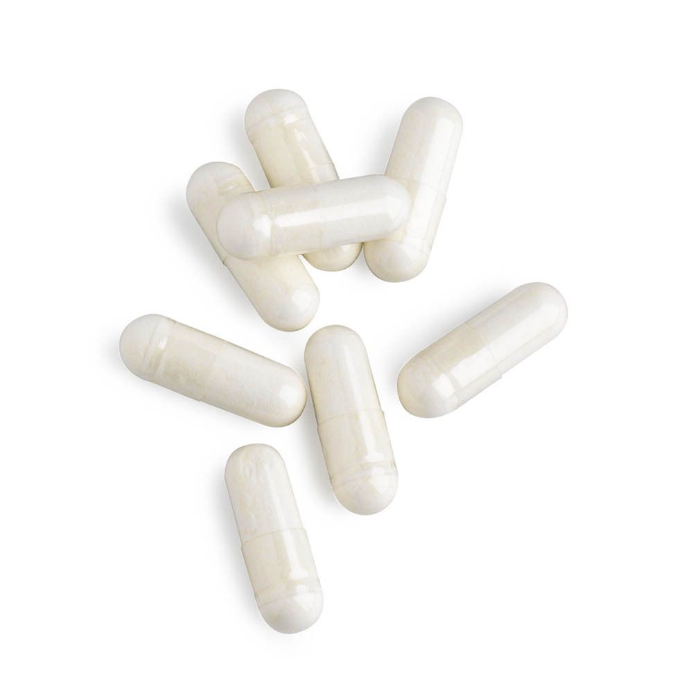 Huit Vegicaps TriBact sur fond blanc.