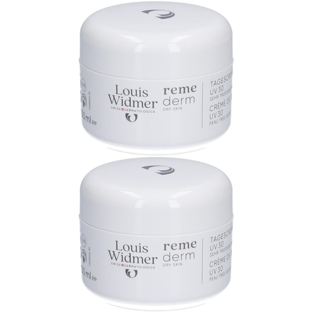 Deux pots de crème blancs avec couvercles. Inscription: Louis Widmer Remederm Dry Skin Crème Visage UV30. Logo et texte.