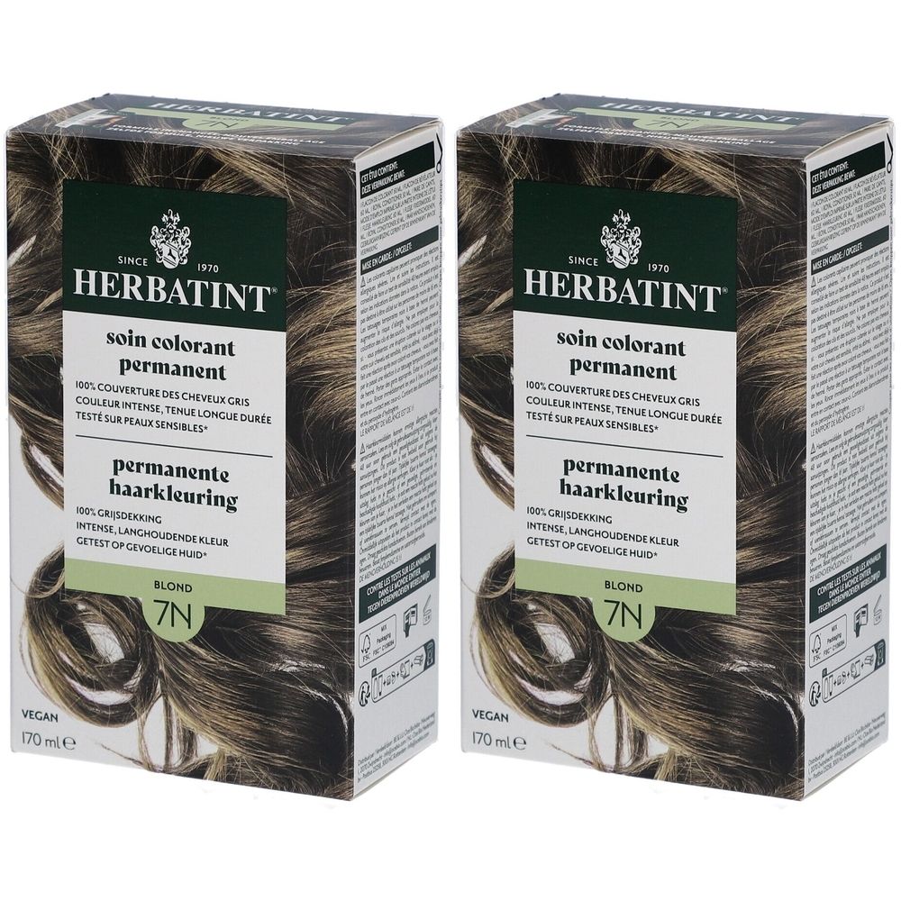 Deux boîtes Herbatint Soin Coloration Permanente 7N Blond. Emballage vert-brun avec informations et illustration de cheveux.