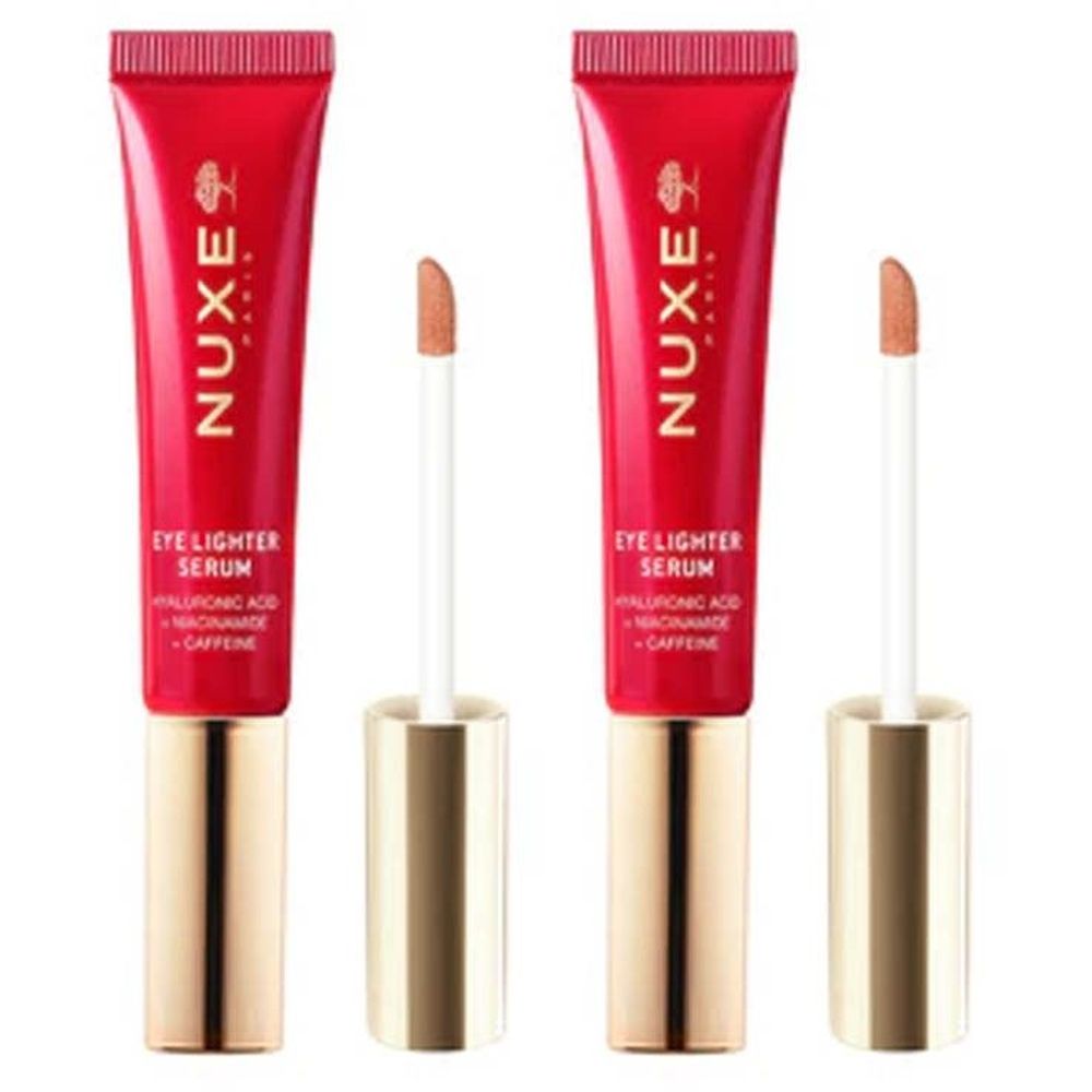 Deux tubes rouges avec bouchons dorés et applicateurs. Inscription: Nuxe Paris, Eye Lighter Serum, Acide hyaluronique, Niacinamide, Caféine.