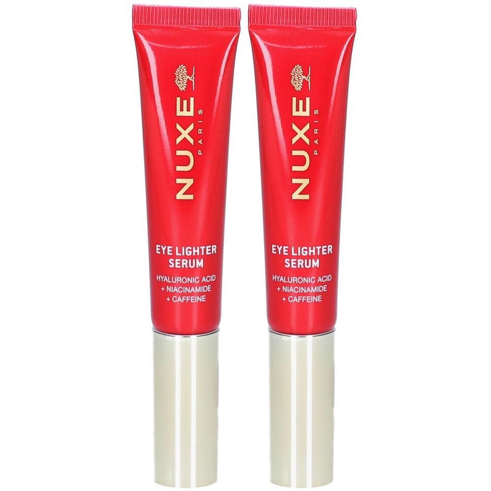 Deux tubes rouges avec bouchons dorés. Inscription: Nuxe Paris, Eye Lighter Serum, Acide hyaluronique, Niacinamide, Caféine.