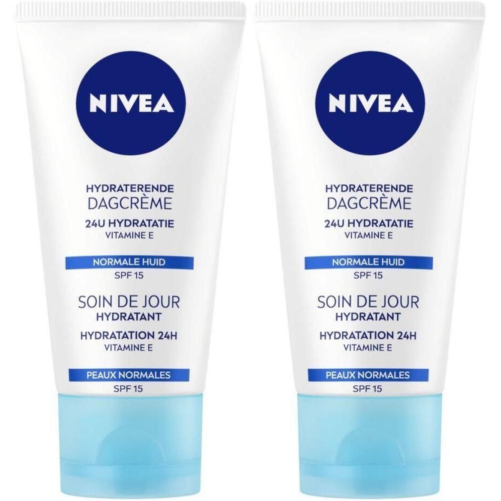 Deux tubes de NIVEA Soin de Jour Hydratant SPF15. Tubes blancs avec bouchon bleu et logo. Texte: Hydratation 24H, Vitamine E, Peaux Normales.