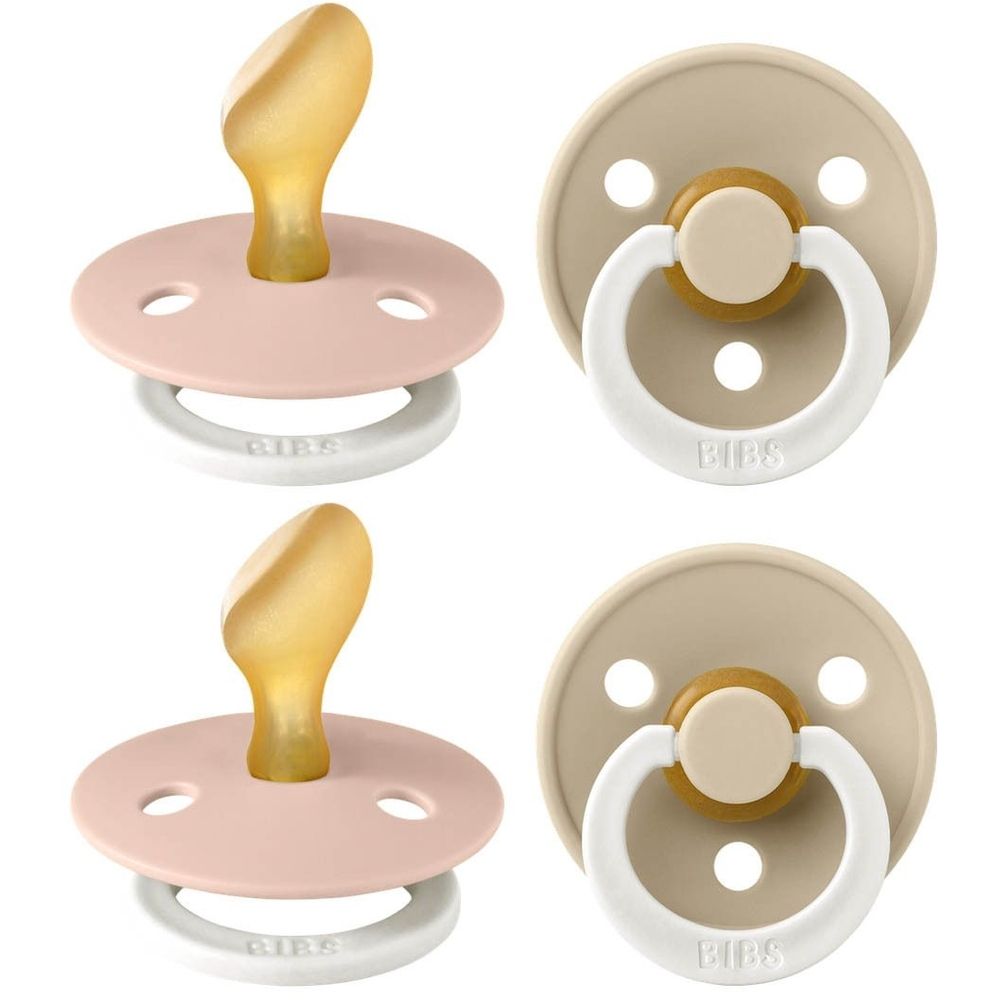 Quatre sucettes. Tétine anatomique. Deux roses, deux beiges. Anneaux et tétines en silicone.