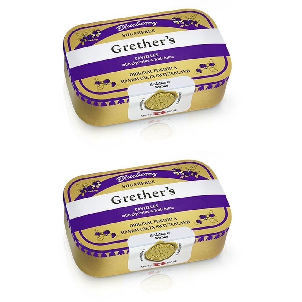 Deux boîtes de pastilles dorées avec couvercle violet. Inscription: Grether's Pastilles Blueberry Sans Sucre. Label de qualité suisse.