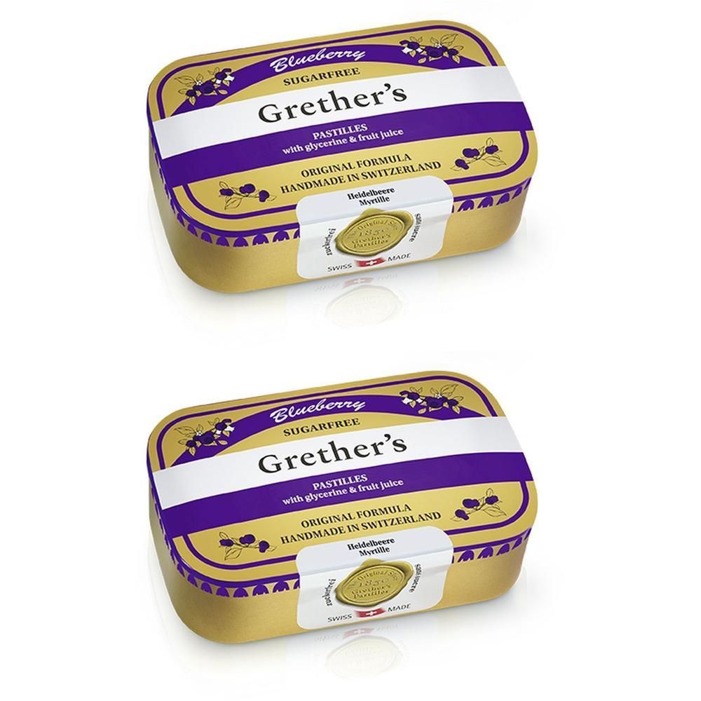 Deux boîtes de pastilles dorées avec couvercle violet. Inscription: Grether's Pastilles Blueberry Sans Sucre. Label de qualité suisse.