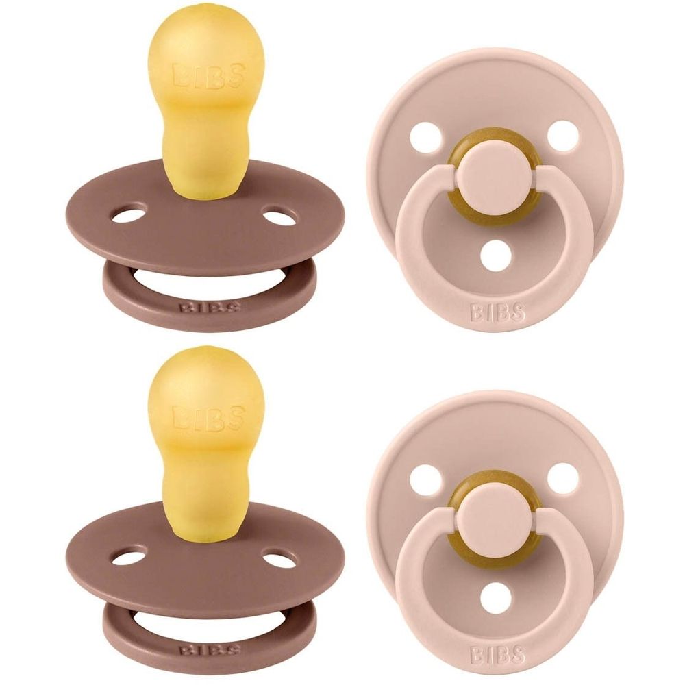Quatre tétines, deux marron, deux roses. Forme ronde, tétine jaune, anneau. Logo BIBS visible.