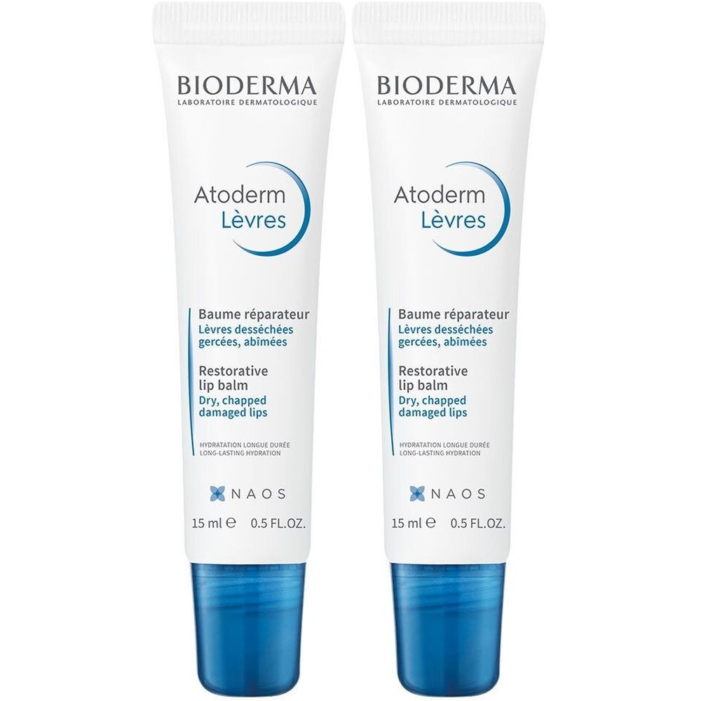 Deux tubes de baume à lèvres blancs et bleus. Inscription: Bioderma, Atoderm Lèvres, Baume réparateur, 15 ml.
