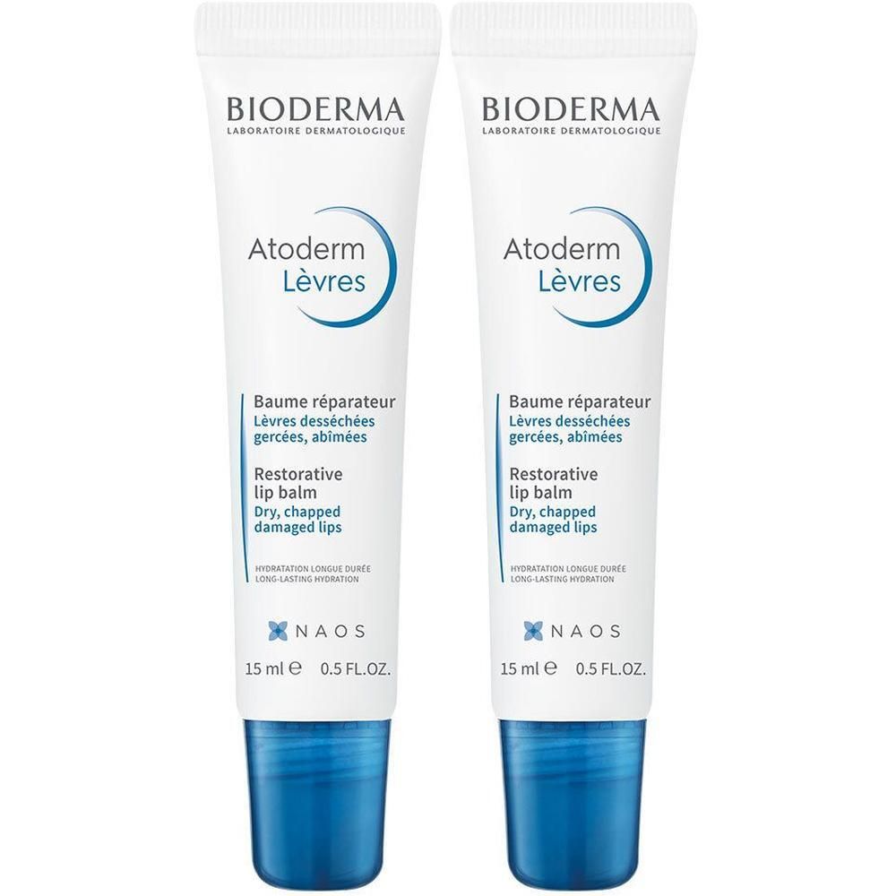 Deux tubes de baume à lèvres blancs et bleus. Inscription: Bioderma, Atoderm Lèvres, Baume réparateur, 15 ml.
