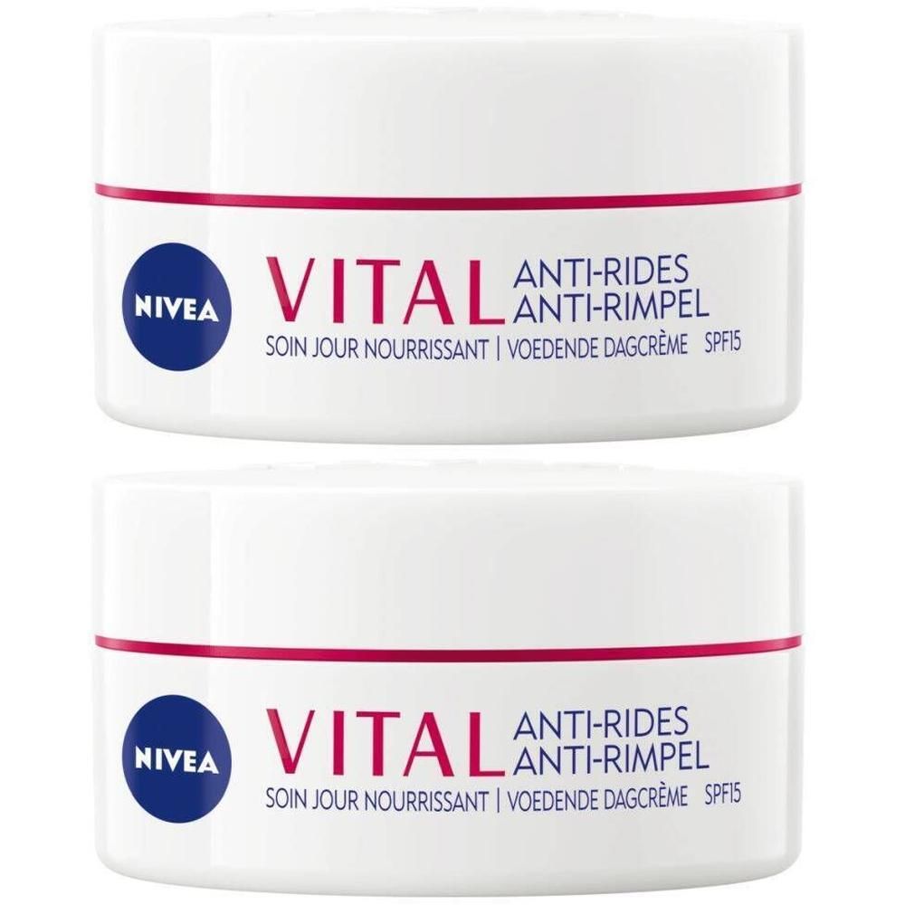 Deux pots blancs avec lettrage rouge et bleu. Inscription: NIVEA VITAL Anti-Rides Soin de Jour Ultra Nourrissant SPF15.