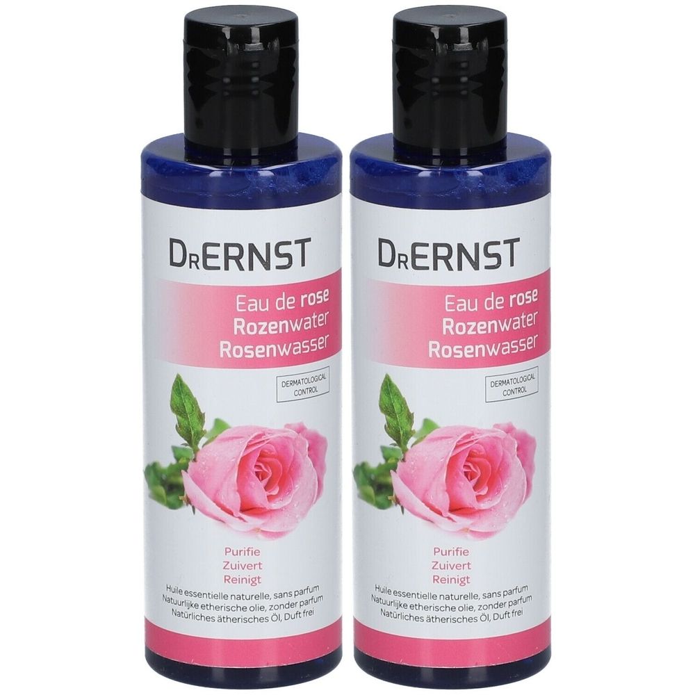 Deux flacons de Dr. Ernst Eau de Rose. Bouteilles bleues avec bouchons noirs. Étiquette avec nom, rose et texte.