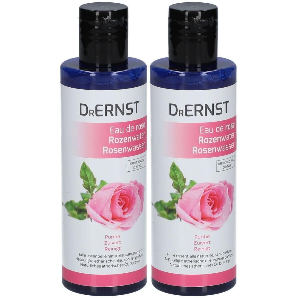 Deux flacons de Dr. Ernst Eau de Rose. Bouteilles bleues avec bouchons noirs. Étiquette avec nom, rose et texte.