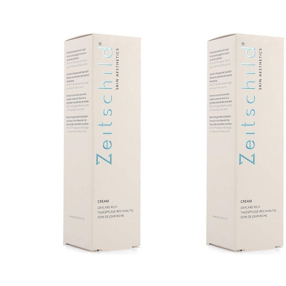 Deux boîtes rectangulaires. Inscription : Zeitschild Skin Aesthetics, Cream, Soin de Jour Riche. Texte bleu clair.