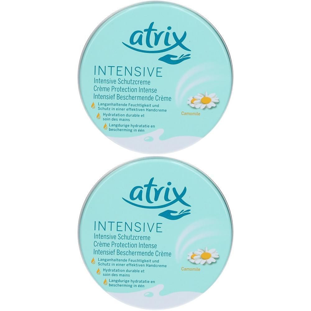 Deux boîtes rondes de crème protectrice intensive Atrix. Couvercle bleu clair avec logo et informations produit. Illustration de camomille.