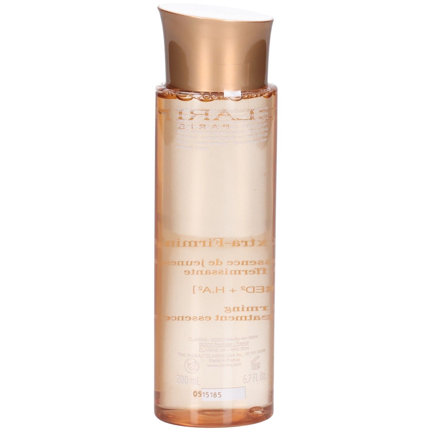 Essence Clarins Extra-Firming : vue arrière d'un flacon à bouchon doré et liquide pêche.