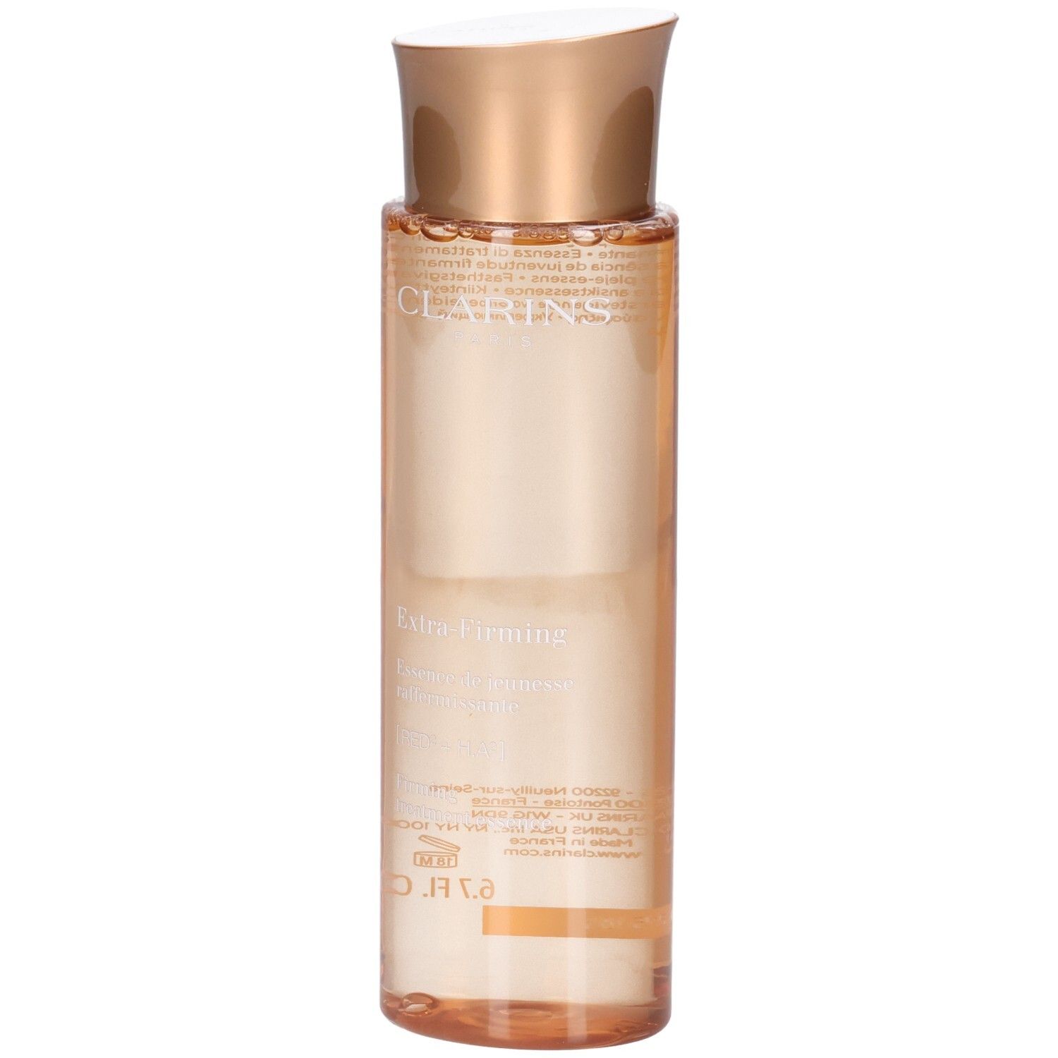 Essence Clarins Extra-Firming : flacon à bouchon doré et liquide pêche.