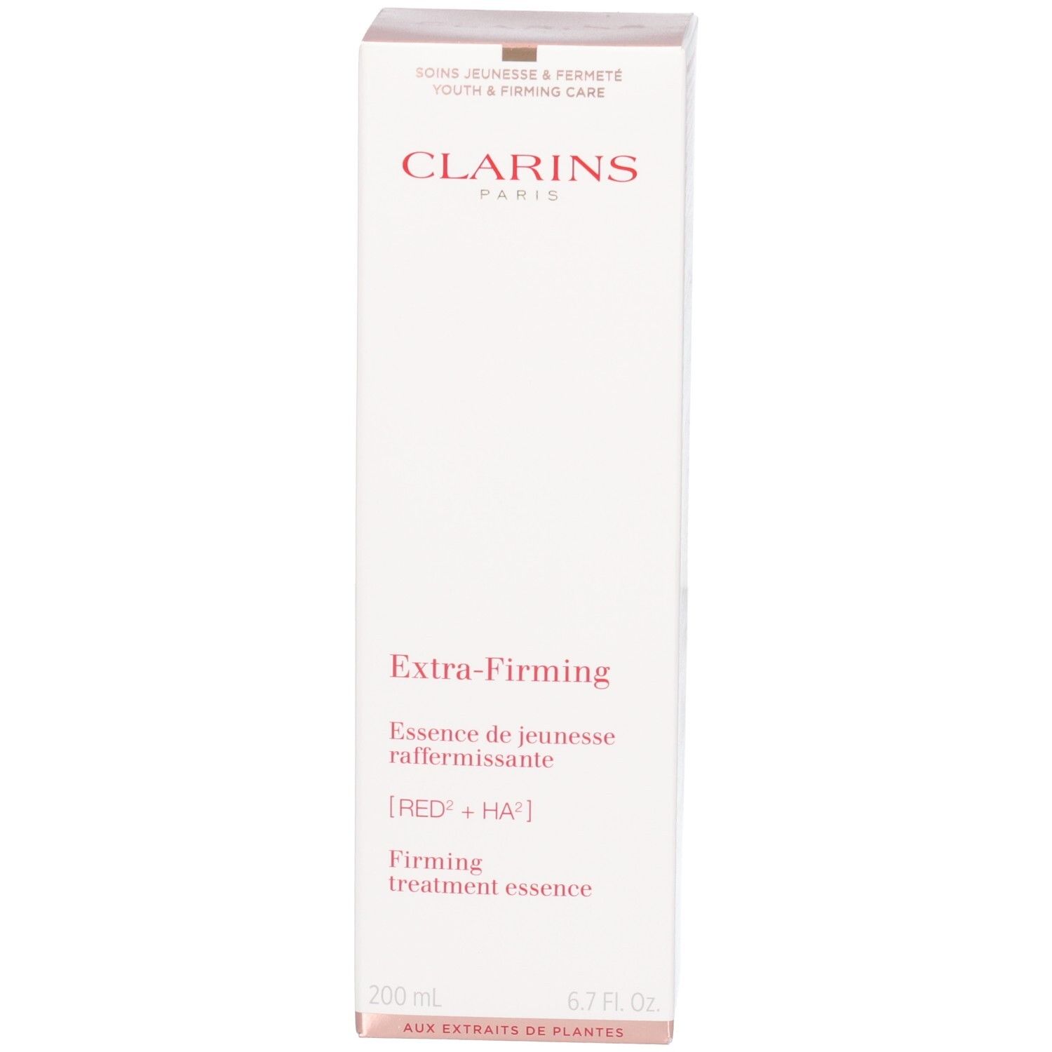 Essence Clarins Extra-Firming : boîte avec bouchon doré et liquide pêche.
