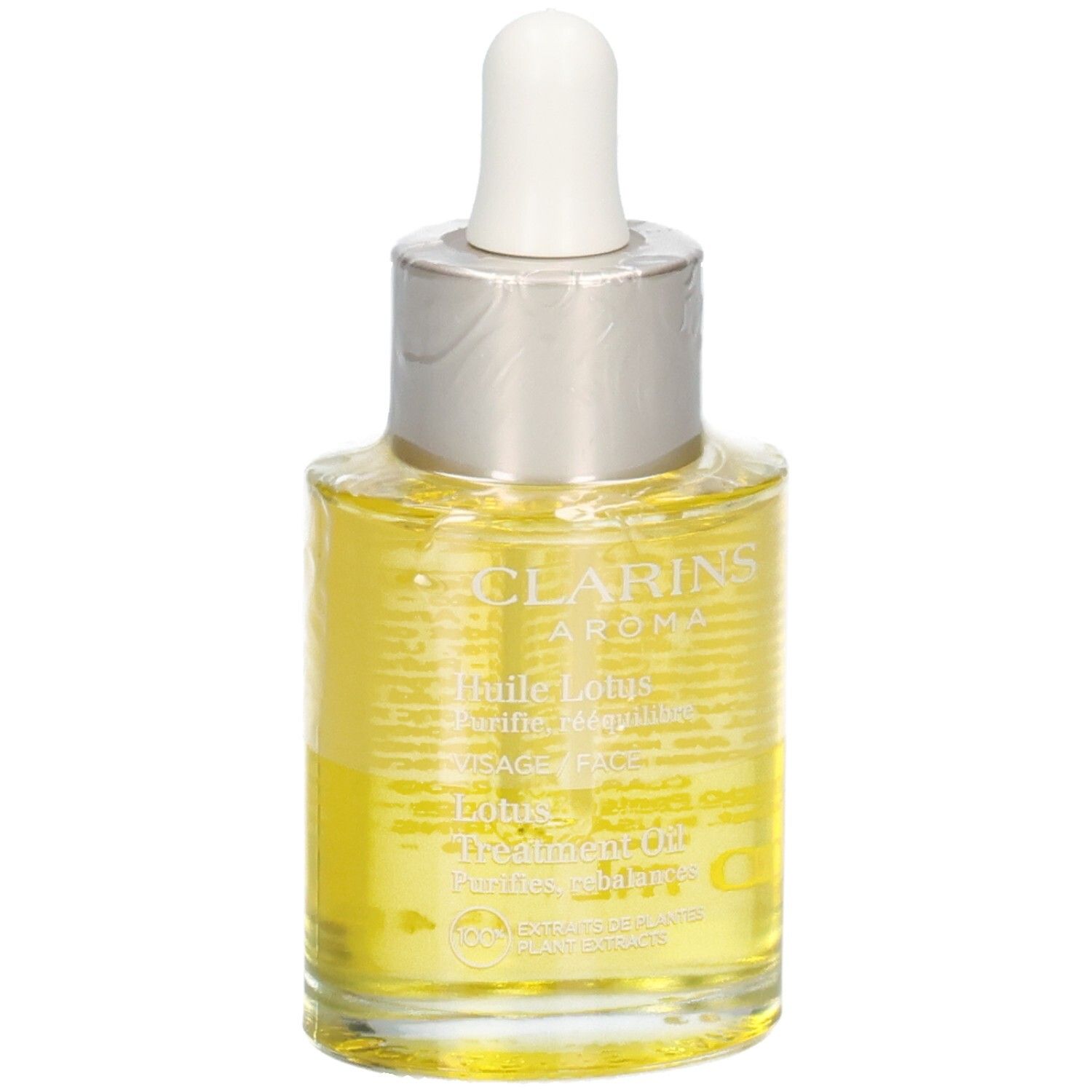 Huile Aroma Lotus Clarins. Liquide jaune dans un flacon en verre avec pipette, avec texte.