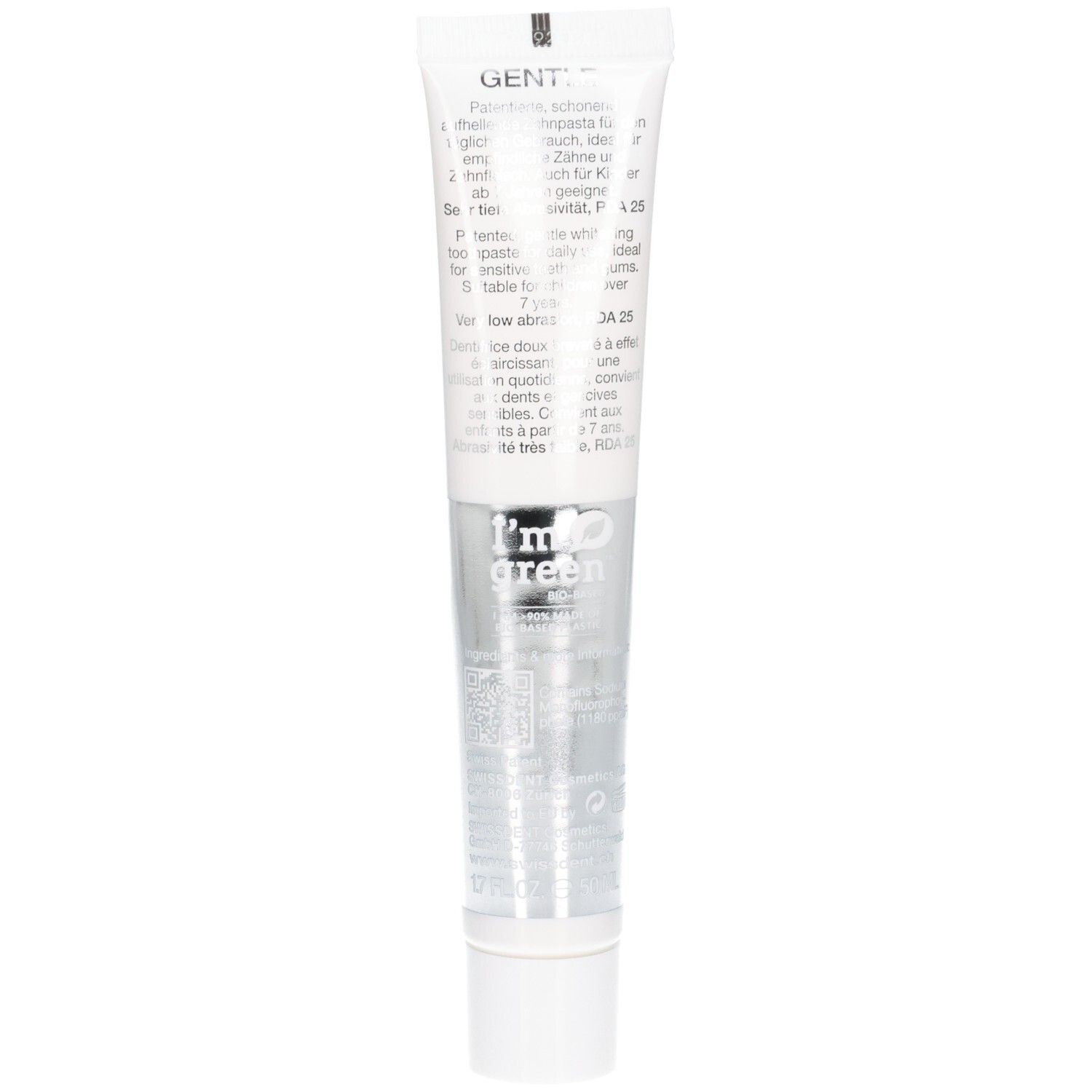 Tube de dentifrice avec bouchon blanc. Texte en plusieurs langues. Inscription: I'm green. Partie centrale argentée.