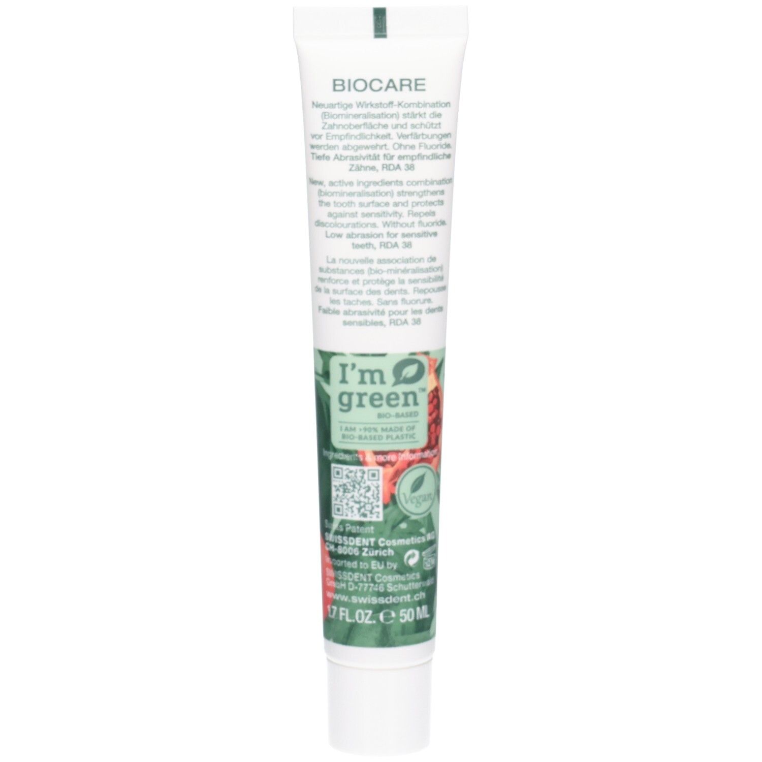 Dos du tube de dentifrice. Informations textuelles, ingrédients et certifications. Couleurs vert et blanc.