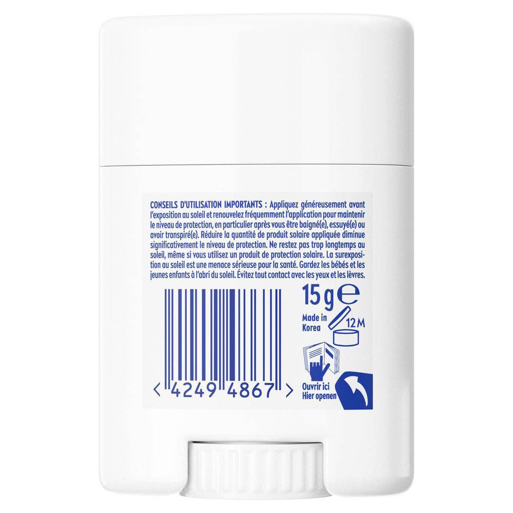 Dos du stick UV blanc. Texte : Conseils d'utilisation, 15g, code-barres, Fabriqué en Corée.