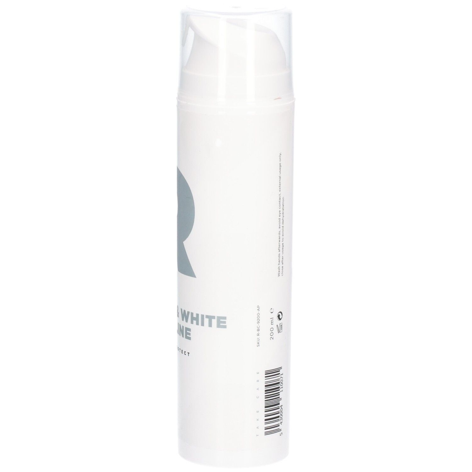 Flacon blanc avec pompe. Inscription : RÉVVI Pure & White Vaseline. Logo gris.
