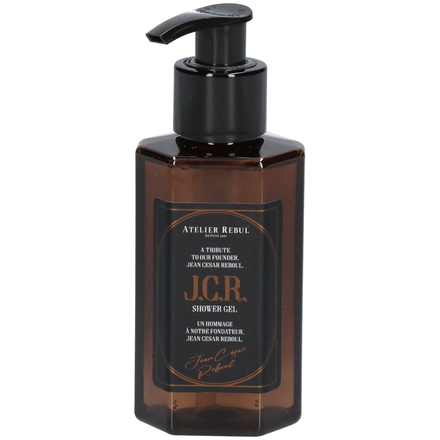 Flacon octogonal marron avec pompe noire. Étiquette avec texte: Atelier Rebul J.C.R. Gel douche.