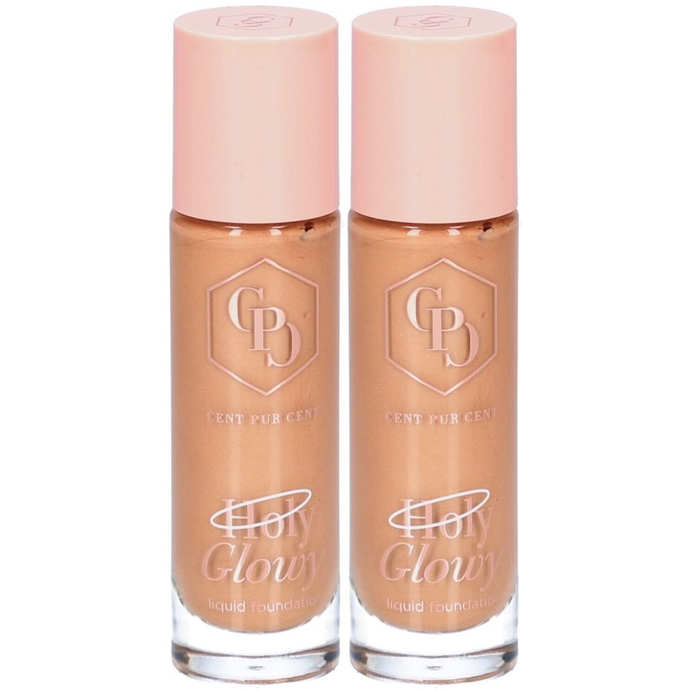 Deux flacons de fond de teint avec bouchons roses. Inscription: Holy Glowy, Cent Pur Cent. Fond de teint liquide.