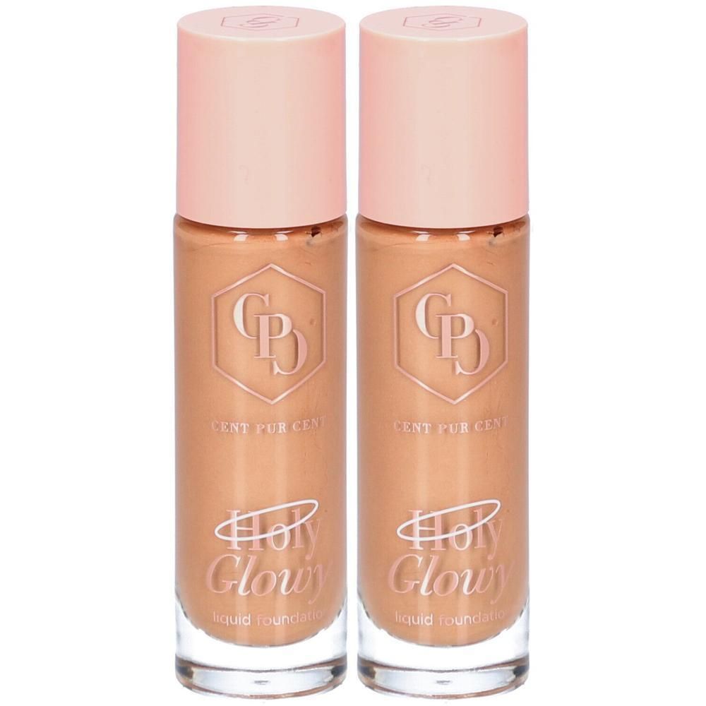 Deux flacons de fond de teint avec bouchons roses. Inscription: Holy Glowy, Cent Pur Cent. Fond de teint liquide.