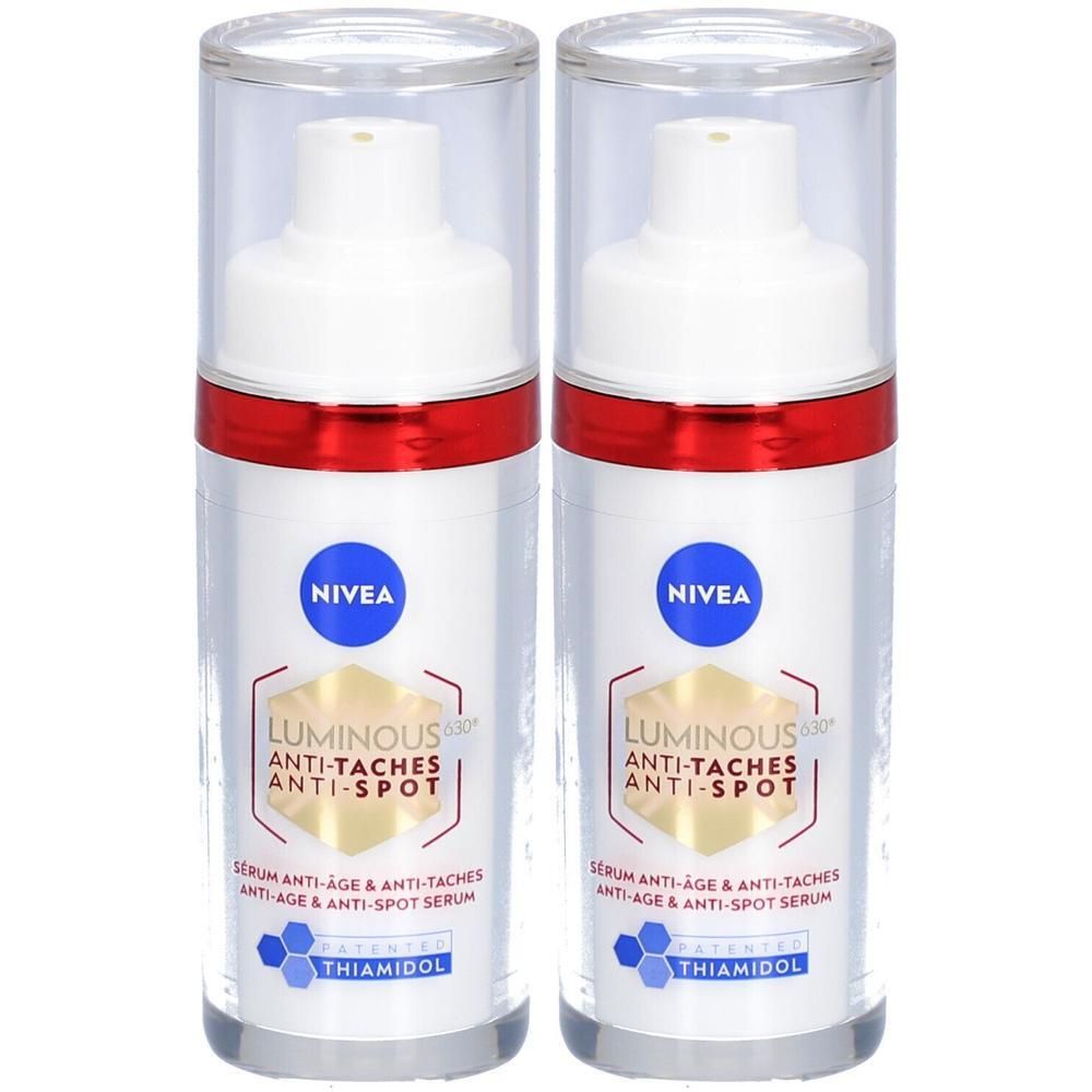 Deux flacons de sérum avec pompe blanche, anneau rouge et couvercle transparent. Texte: NIVEA, Luminous Anti-Taches Anti-Spot.
