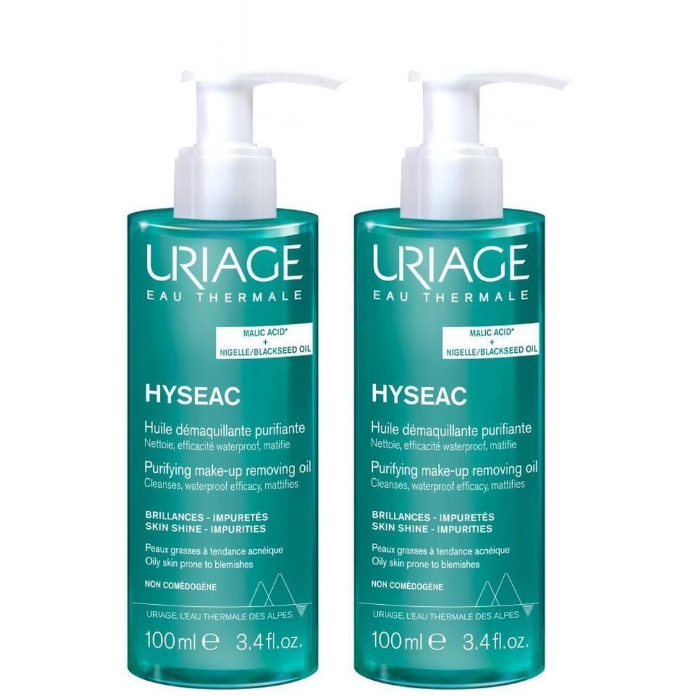 Deux flacons Uriage Hyseac Huile Démaquillante Purifiante avec pompe. Étiquettes vertes, pompe blanche, nom du produit visible.
